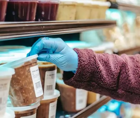 hand checking the nutrition facts label of a food product