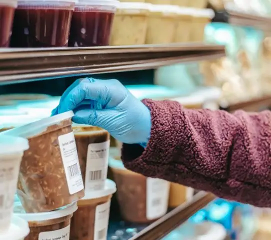 hand checking the nutrition facts label of a food product