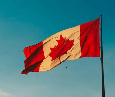 Canadian flag with clear, blue sky in the background